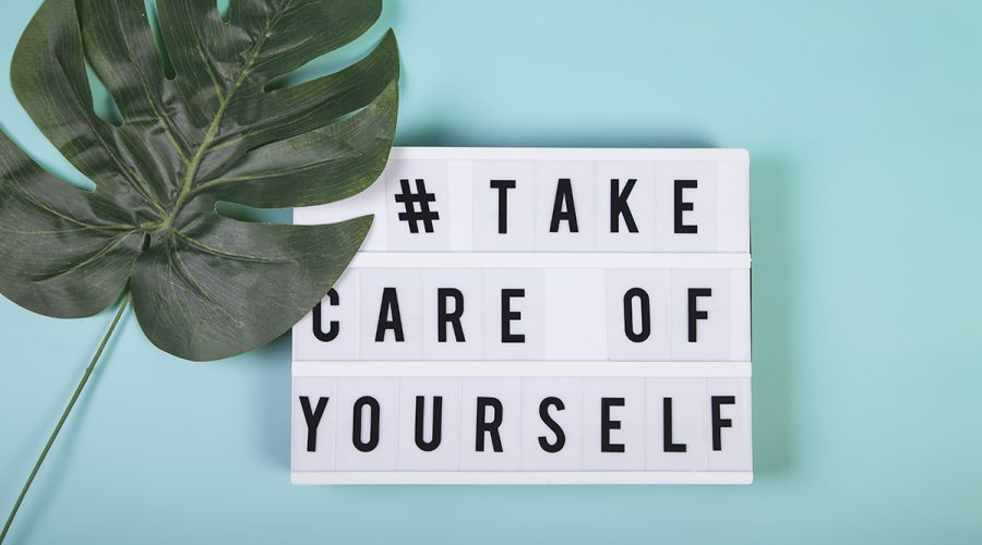 Lightbox with motivational words for self-care, mental health, emotional well-being. Top view.